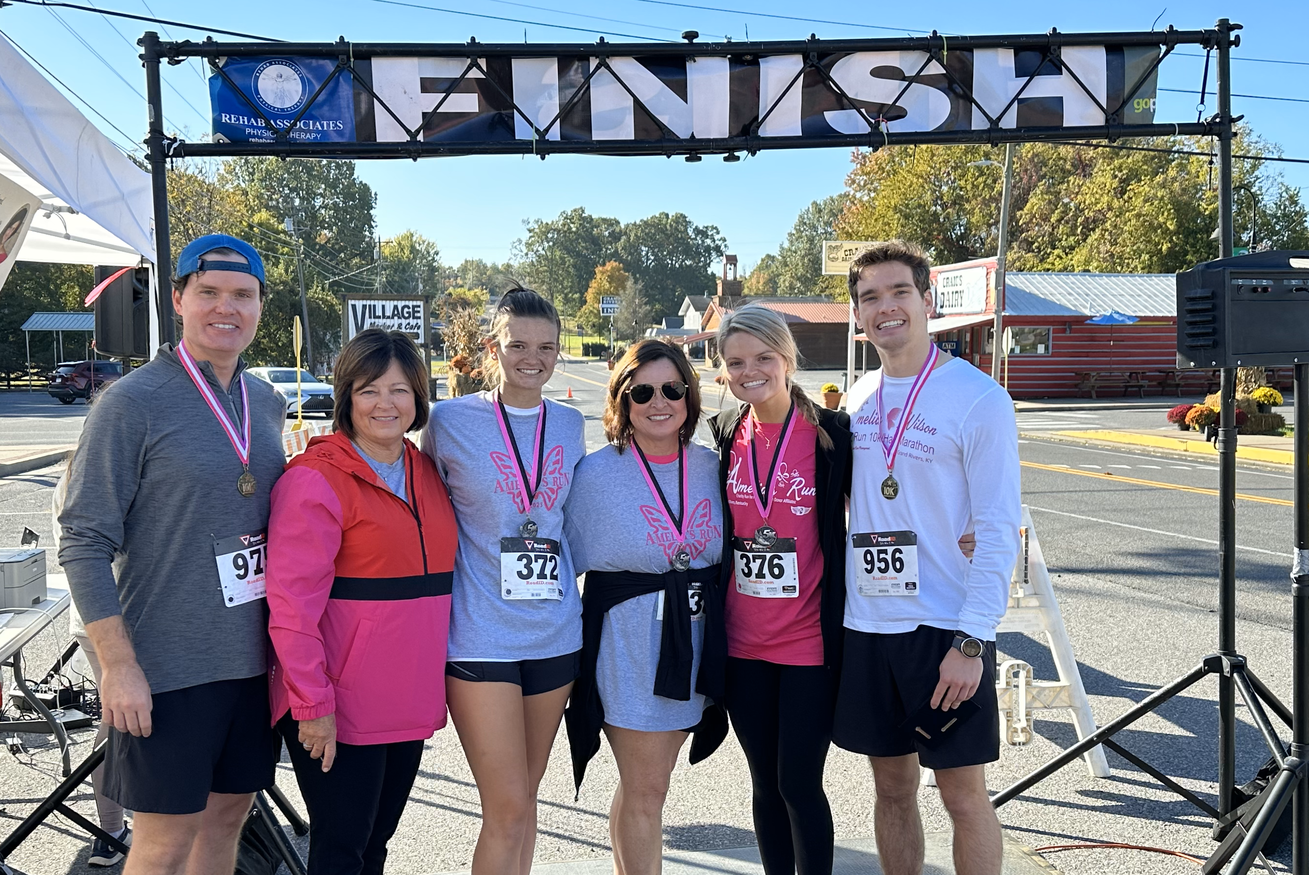 Family standing under 5k finish line