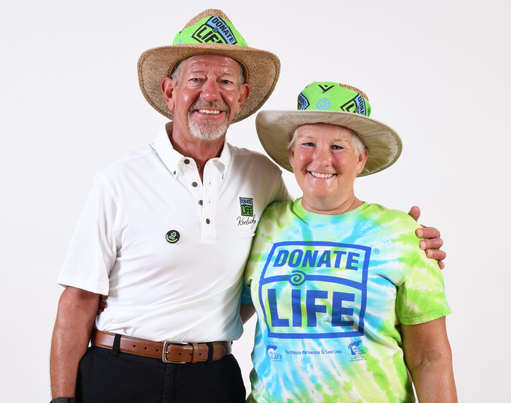 Gentleman and wife posing for photo wearing Donate Life wear.