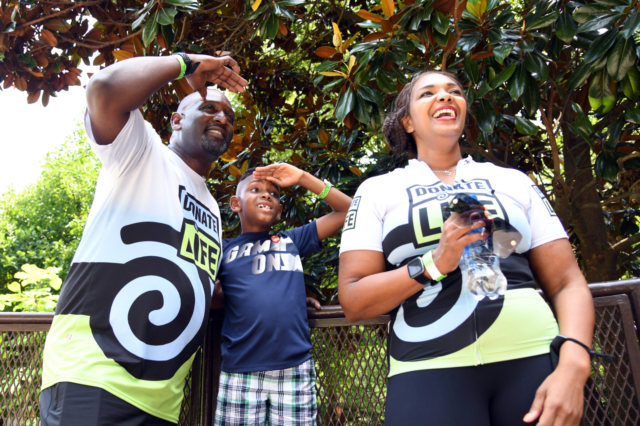 Family looking out while wearing Donate Life logo shirts.