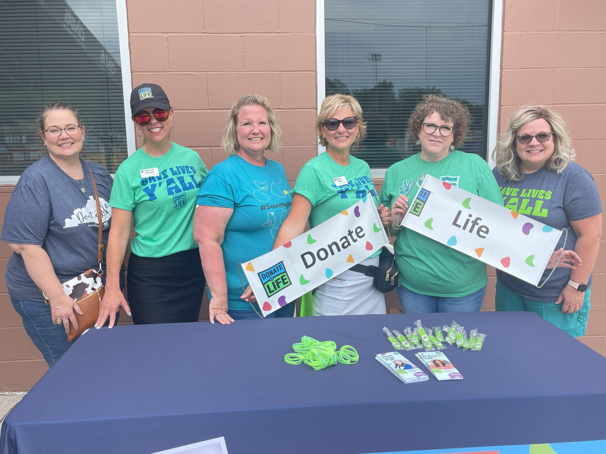 Group of ladies working a Donate Life info table.